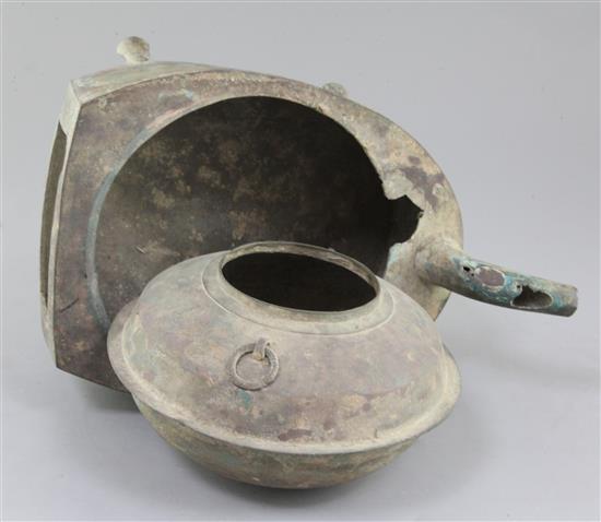 A Chinese archaic bronze steamer vessel, in two parts, Xian, Han dynasty, 206 B.C.-220 A.D., 30cm long, holes